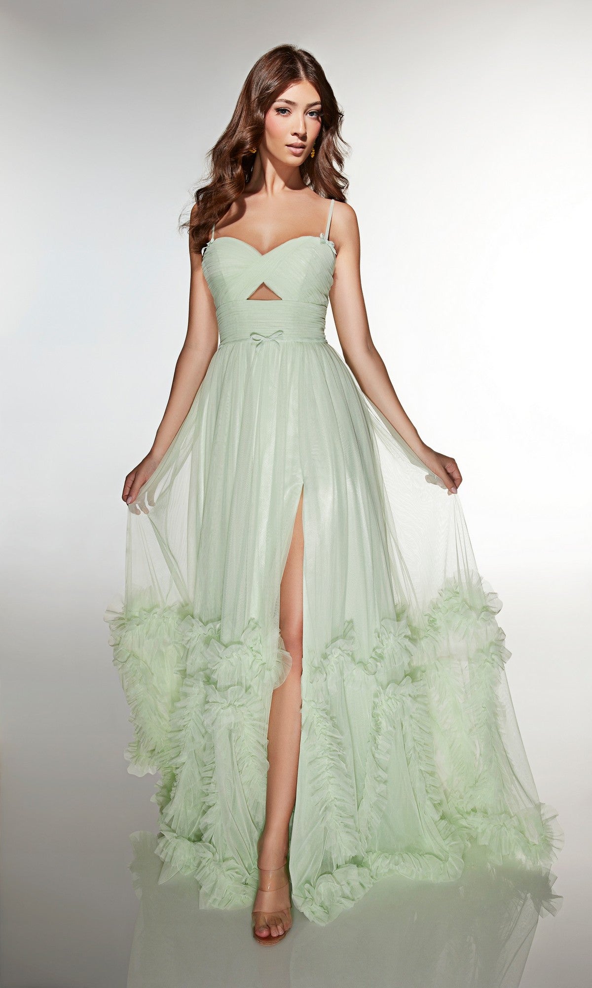 A woman models the Alyce 62043 long prom dress in mint, featuring a sleeveless design, sweetheart neckline, front slit, and ruffled details against a plain background.